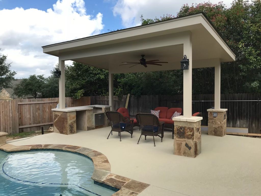 Covered patio beside a swimming pool