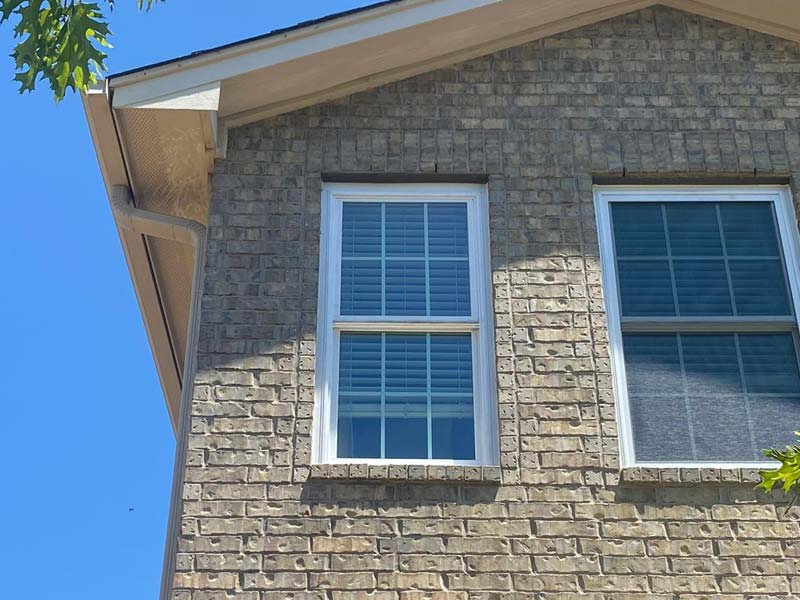 White replacement windows in a brick home
